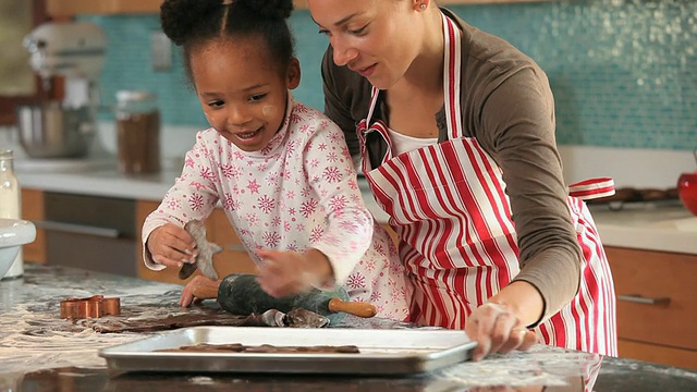 美国弗吉尼亚州里士满，母亲在厨房帮女儿(4-5岁)做姜饼视频素材