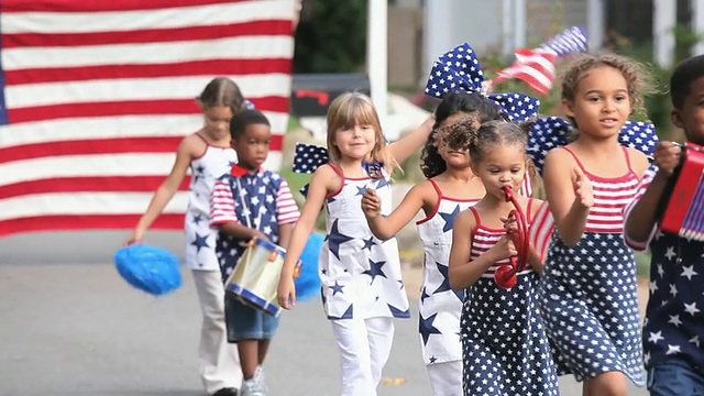 一群孩子(2-7)在美国弗吉尼亚州里士满的独立日游行中行走。视频素材