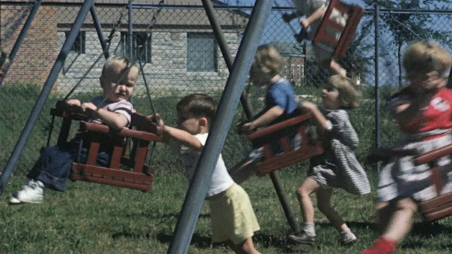 1956年微软儿童在操场上荡秋千/美国视频素材