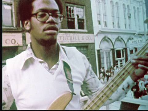 1976戴眼镜的蒙太奇男子弹奏电子贝司吉他。情侣舞/美国宾夕法尼亚州费城视频下载
