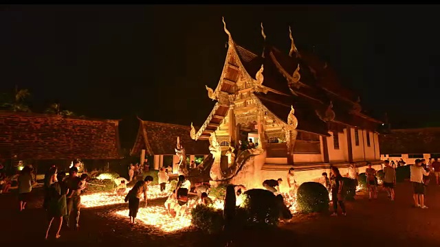 泰国清迈——2017年5月:维萨卡布茶日，人们在通昆寺点燃蜡烛祈祷。噪音和高ISO剪辑视频下载