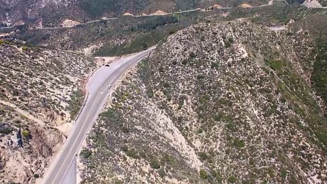 在加州拉Cañada福林特里奇，一辆汽车在多风的山路上的空中上升视图视频下载