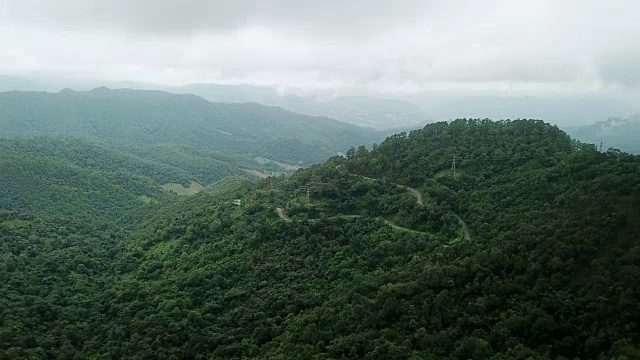 鸟瞰图蜿蜒的道路在森林和汽车驾驶，安全驾驶的概念视频素材