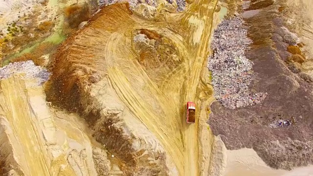 卡车在泥泞的道路上行驶的鸟瞰图。从上面看重工业。视频素材