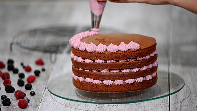 准备制作浆果巧克力蛋糕。女人的手装饰蛋糕。视频素材