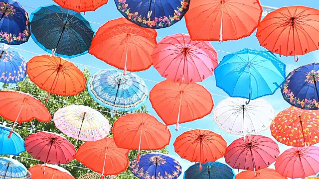 蓝天上五颜六色的雨伞视频下载