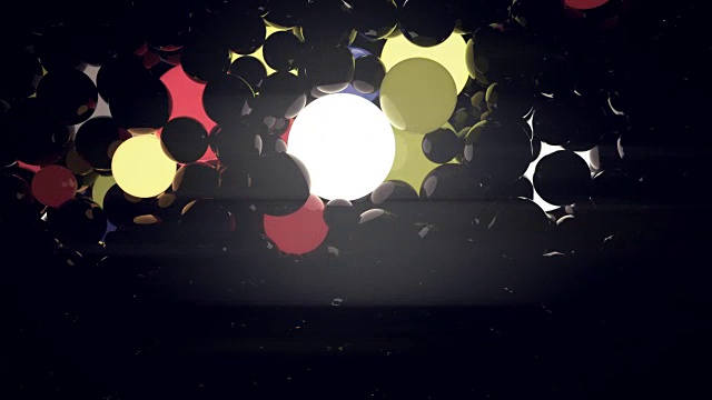黑色背景上的彩色发光球。数字动画3d渲染。4K，超高清分辨率视频素材