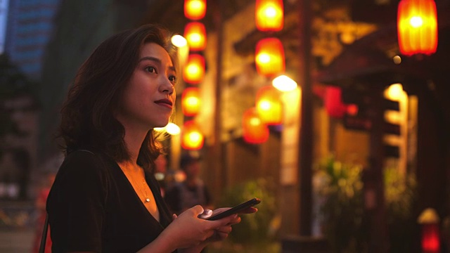 年轻的中国女子在街上打电话视频素材
