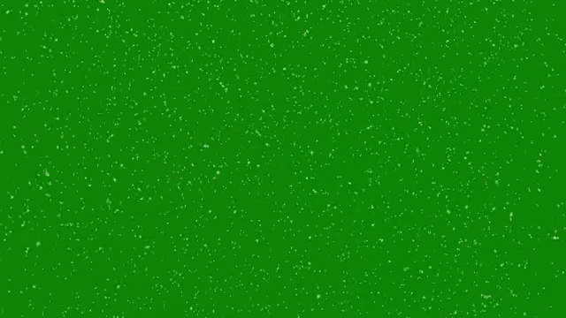真实的雪花在绿色屏幕前落下。冬天的创作背景视频素材