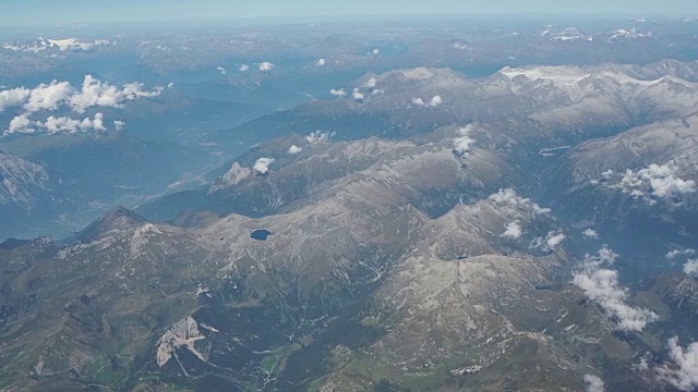 在夏季飞越欧洲阿尔卑斯山。从飞机窗口鸟瞰图视频下载