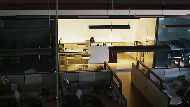 年轻的女商人在空荡荡的办公室里工作，居高临下视频素材