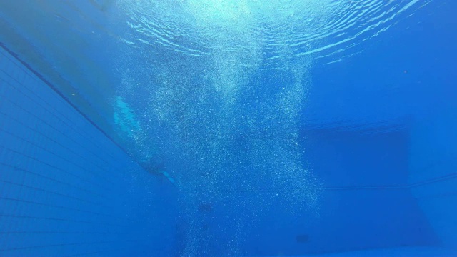 一名女跳水运动员在水中着陆，在一团气泡中转弯视频下载