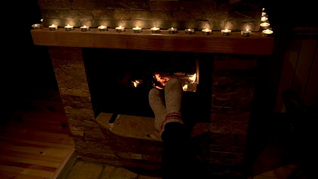 女孩的脚在壁炉前暖着。视频素材