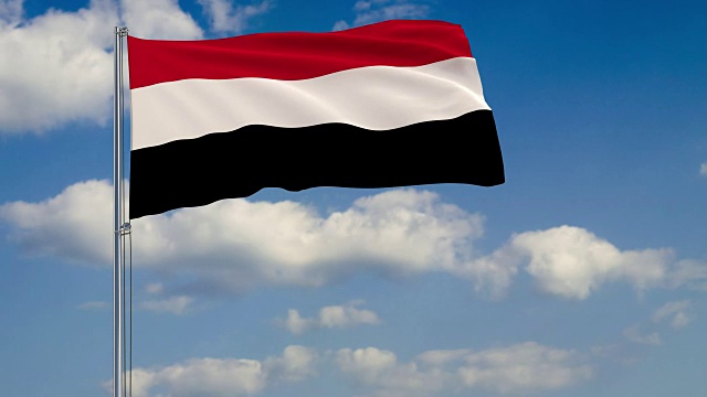 也门的国旗映衬着漂浮在蓝天上的云朵视频下载