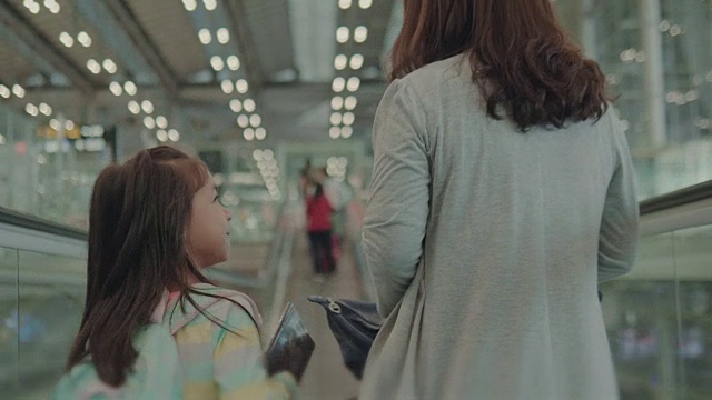 母亲和女儿在机场散步。视频素材
