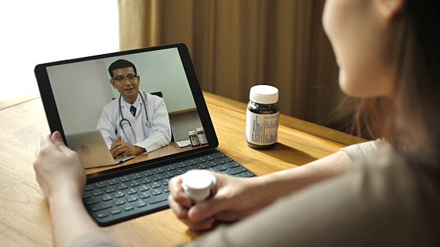 女病人在家用平板电脑与医生视频会议视频素材