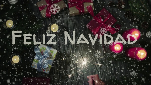 圣诞快乐，西班牙语，女性的手拿着一个烟花视频下载