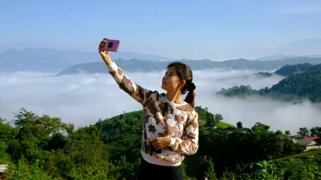亚洲女性的生活方式使用手机自拍与良好的视野视频下载