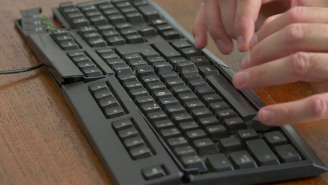 在一个破旧的黑色键盘上打字视频素材