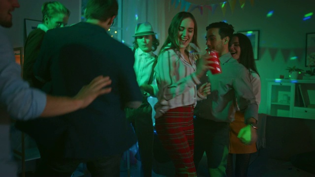在家庭聚会上:各种各样的朋友一起玩，跳舞，跳，社交和喝酒。时尚青年俱乐部。迪斯科霓虹灯。视频下载