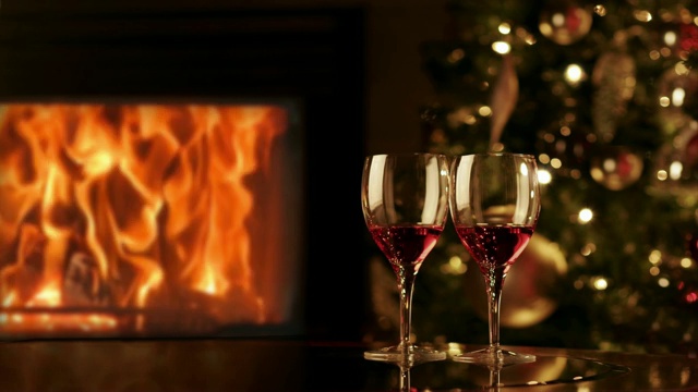 壁炉边放两杯红酒。温馨浪漫的夜晚，靠近壁炉。4 k视频下载