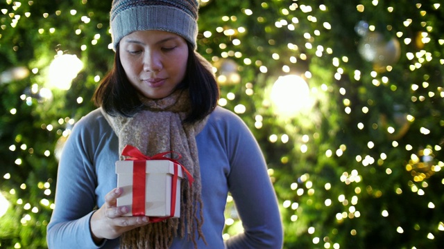 女人手拿礼盒庆祝圣诞节和新年晚会，慢镜头视频素材
