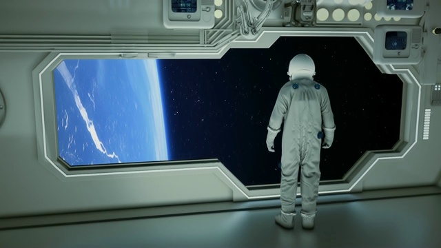 在宇宙飞船上观察地球的宇航员视频素材