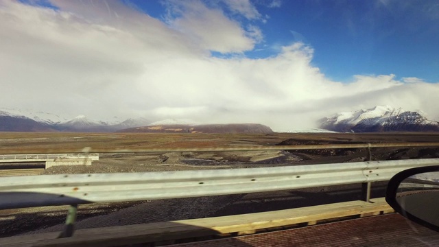 沿冰岛阳光明媚的山路行驶的汽车视角视频素材