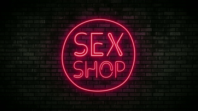 砖墙上的性商店霓虹灯。闪烁的霓虹灯夜总会酒吧。视频下载