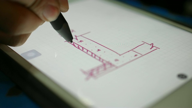 建筑工程师在晚上在数字平板电脑上绘制结构视频素材