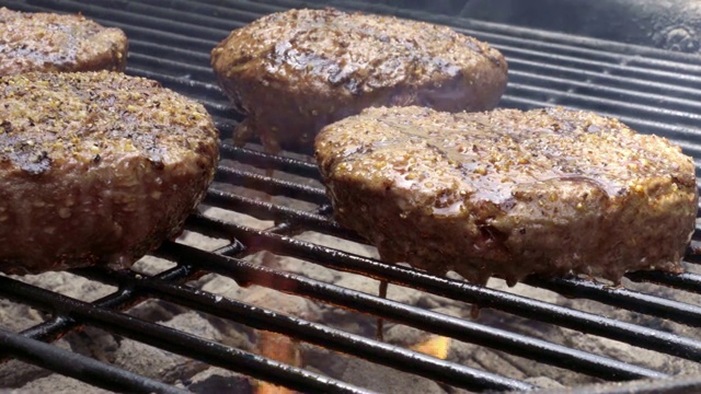 瘦肉健康的汉堡在一个户外木炭烤架上用火焰烤视频下载