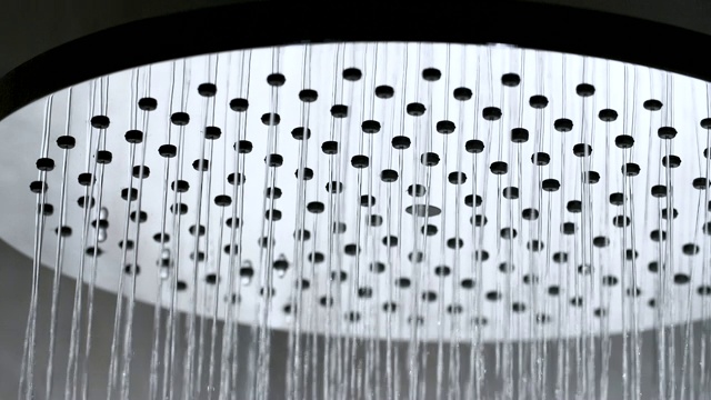淋浴流动的特写和慢镜头，银色淋浴头在浴室视频下载