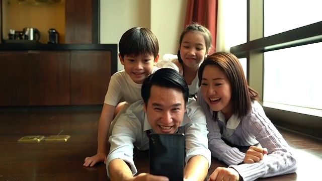 幸福的家庭在客厅对着镜头微笑。视频素材
