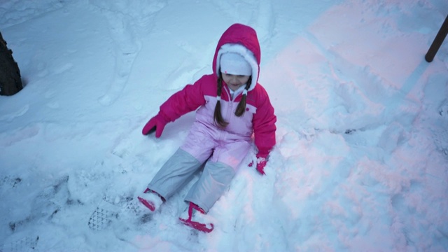 可爱的孩子在户外做雪天使视频下载