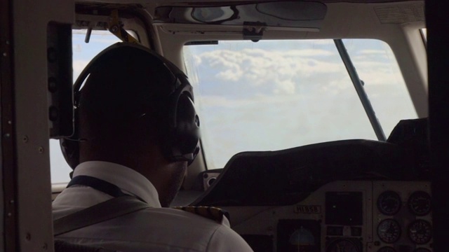 慢镜头:驾驶舱内戴着墨镜的飞行员视频素材