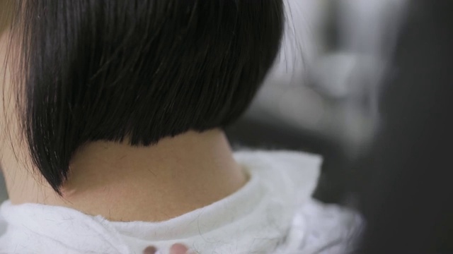 理发师用刷子把顾客肩上剪下来的头发拂走视频下载