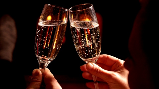 浪漫的情侣用香槟举杯，在火旁放松视频下载
