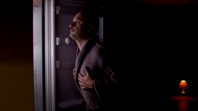 饥饿的男人打开空冰箱往里面看寻找食物和失望视频下载