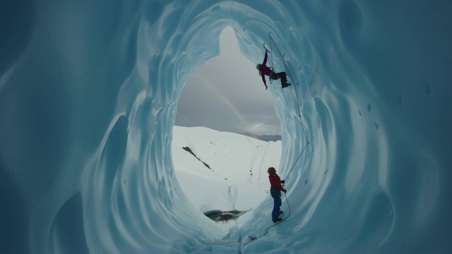 保护员协助冰攀登者攀登彩虹冰川隧道附近/帕尔默，阿拉斯加，美国视频素材