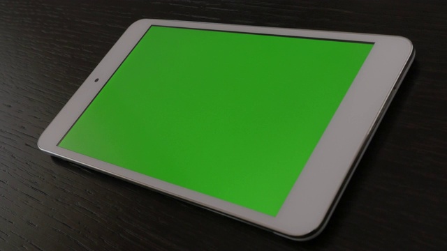 绿屏平板显示在暗木表面慢盘4K视频下载