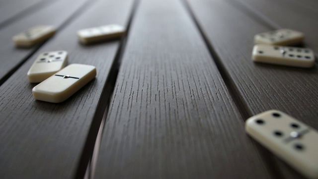 多米诺瓷砖落在桌子上的慢动作视频素材