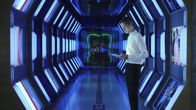 商人在宇宙飞船走廊使用平板电脑视频素材