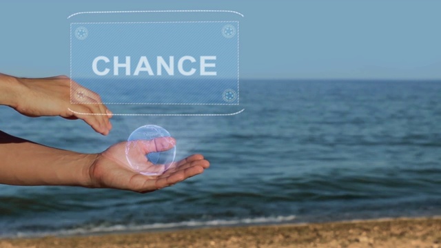 海滩上的男性手拿着一个带有Chance文字的概念全息图视频下载