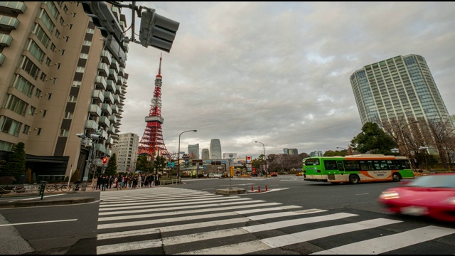 人群过马路时，红绿灯和汽车的后面左边是东京塔——日本东京视频素材