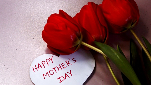 心形贺卡上写着“母亲节快乐”，红色郁金香上写着“感激”视频下载