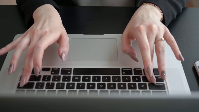 裁剪镜头的年轻聪明的女学生学习通过笔记本电脑前她的讲座，聪明的女人坐在前面打开上网本视频素材