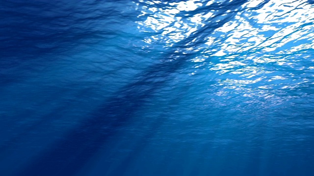 阳光从上面照射下来，穿透深蓝色的海水，形成美丽的水幕反射光线视频素材
