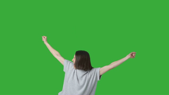 兴奋的女人在绿色背景下庆祝成功视频素材