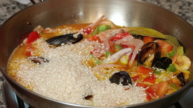将米饭放入锅中煮蔬菜和海鲜视频素材