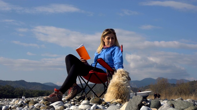 女人看书和狗。视频素材